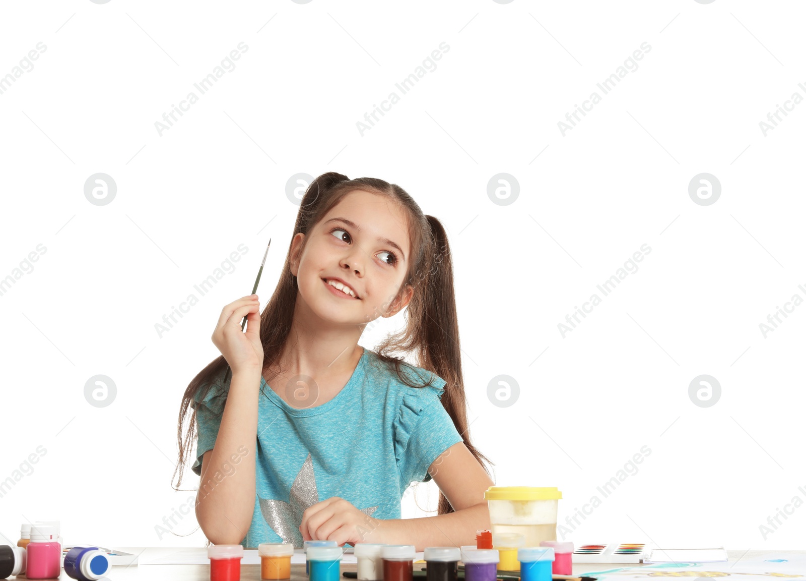 Photo of Cute child painting picture at table on white background