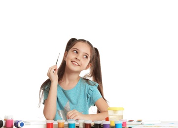 Photo of Cute child painting picture at table on white background