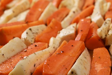 Photo of Slices of parsnip and carrot on baking tray, closeup