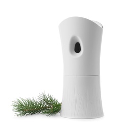 Automatic air freshener and fir branch on white background