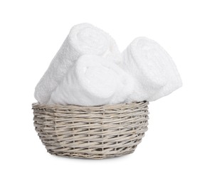 Photo of Wicker basket with rolled bath towels isolated on white