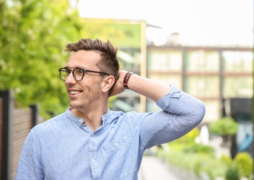 Photo of Portrait of attractive young man in stylish outfit outdoors