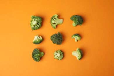 Photo of Flat lay composition with fresh green broccoli on color background