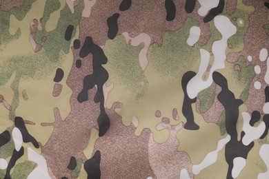 Photo of Texture of camouflage fabric as background, top view