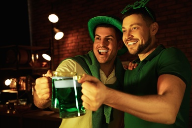 Photo of Men with beer celebrating St Patrick's day in pub