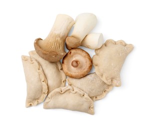 Photo of Raw dumplings (varenyky) and fresh mushrooms isolated on white, top view