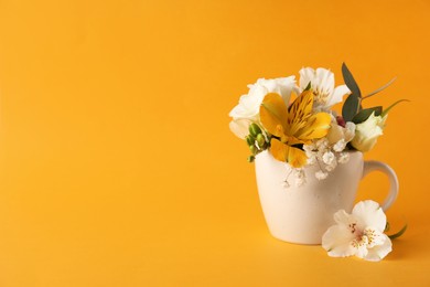 Photo of Bouquet of beautiful flowers in cup on yellow background, space for text