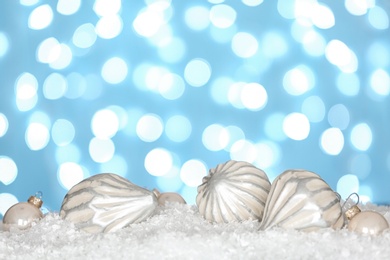 Christmas decoration on snow against blue background