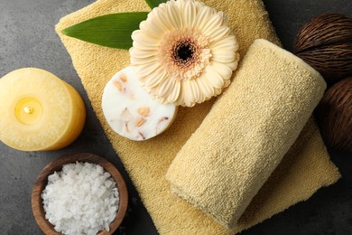 Flat lay composition with different spa products and candle on grey table