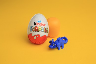 Photo of Sveti Vlas, Bulgaria - July 3, 2023: Kinder Surprise Egg, plastic capsule and toy on yellow background
