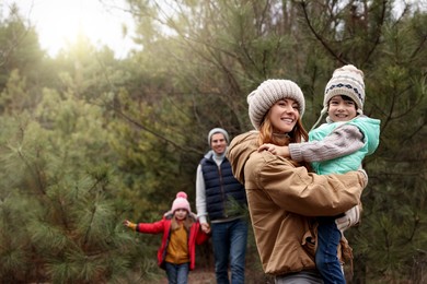 Photo of Happy family spending time together in forest