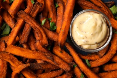 Photo of Delicious sweet potato fries served with sauce, closeup