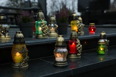 Photo of Grave lights on granite surface at cemetery
