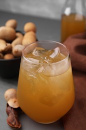 Photo of Freshly made tamarind juice on grey table, closeup