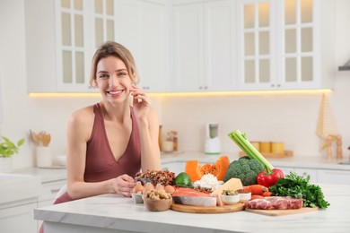 Photo of Woman with healthy food in kitchen. Keto diet