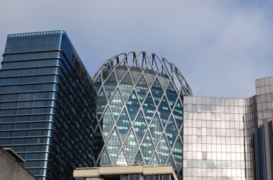 Photo of Exterior of different modern skyscrapers against blue sky