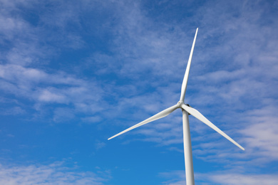 Photo of Wind turbine against beautiful blue sky. Alternative energy source