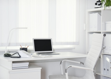 Photo of Doctor's workplace near window in medical office