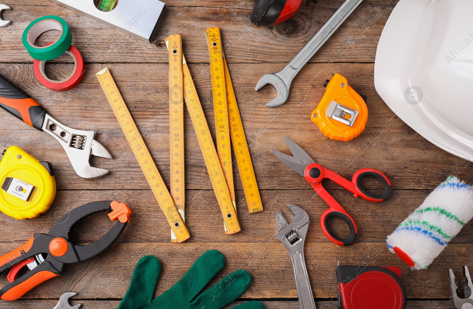 Photo of Flat lay composition with construction tools on wooden background