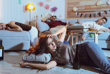 Photo of Group of friends in messy room after party