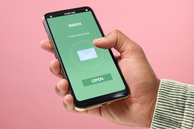 Image of Got new message. Man using smartphone on pink background, closeup