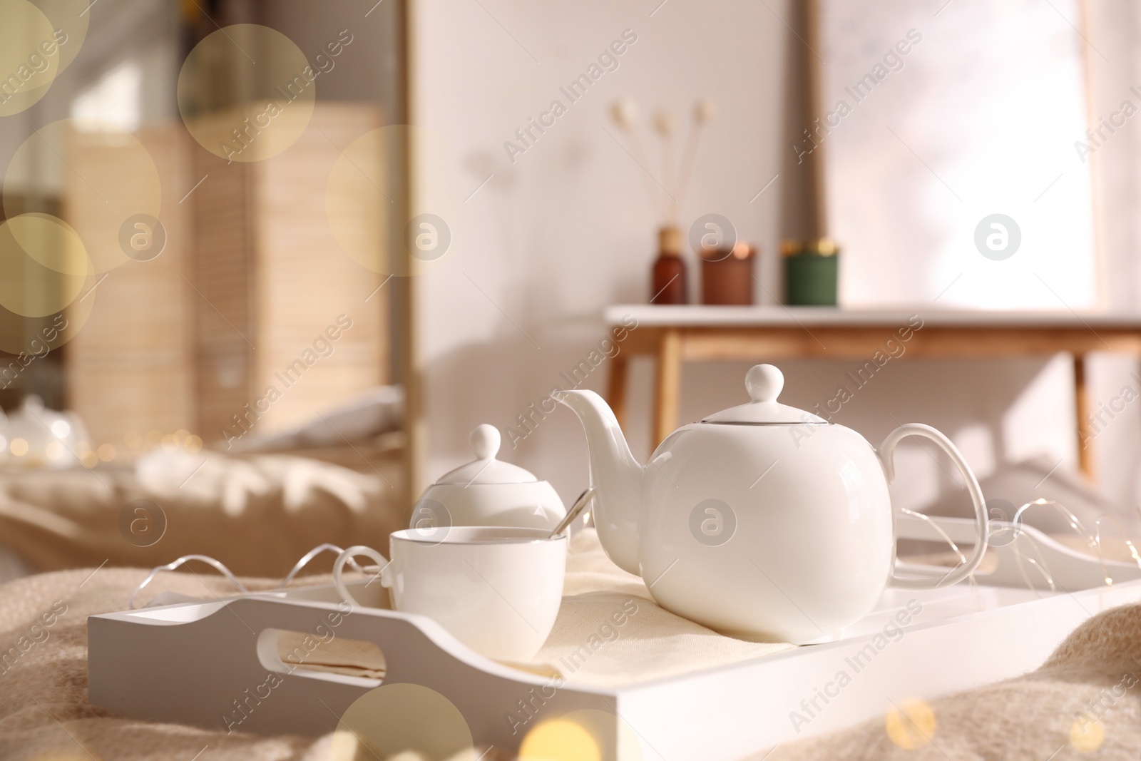 White tray with ceramic tea set in room Photo of White tray with ceramic tea set in room