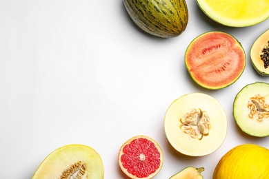 Photo of Ripe tasty melons and fresh tropical fruits on white background, top view