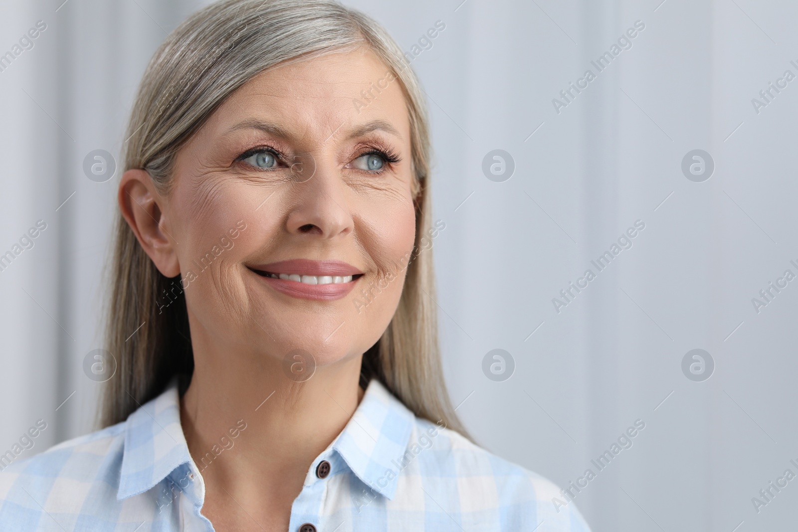 Photo of Portrait of beautiful senior woman indoors. Space for text