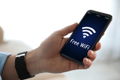 Image of Man using mobile phone connected to WiFi, closeup