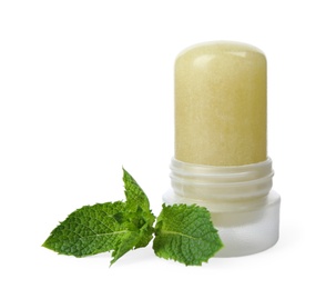 Photo of Natural crystal alum deodorant and mint on white background