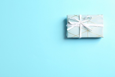 Beautiful gift box on color background, top view with space for text