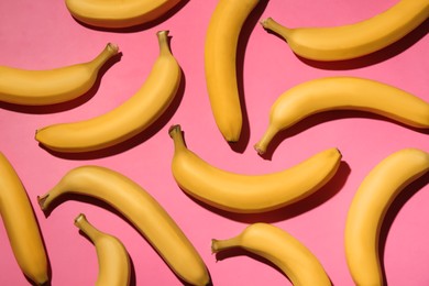 Photo of Ripe yellow bananas on pink background, flat lay