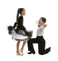 Photo of Beautifully dressed couple of kids dancing on white background