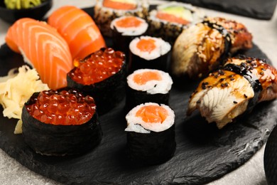 Photo of Set of delicious sushi rolls on light table, closeup