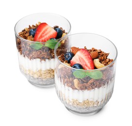 Photo of Tasty granola with berries, nuts, yogurt and chia seeds in glasses isolated on white