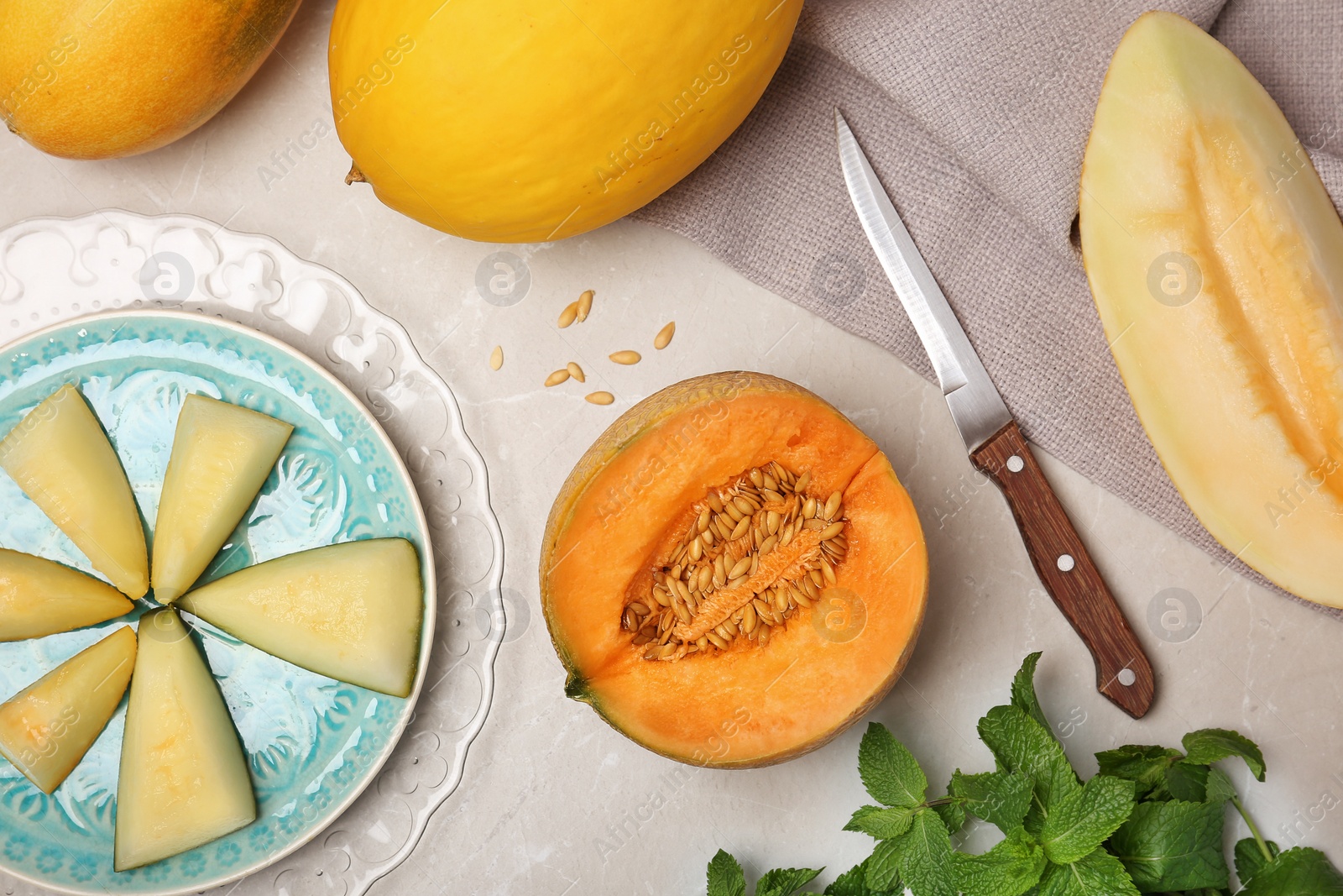 Photo of Flat lay composition with cut fresh tasty melons on table