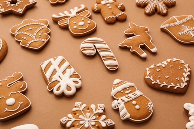 Different Christmas gingerbread cookies on brown background, closeup