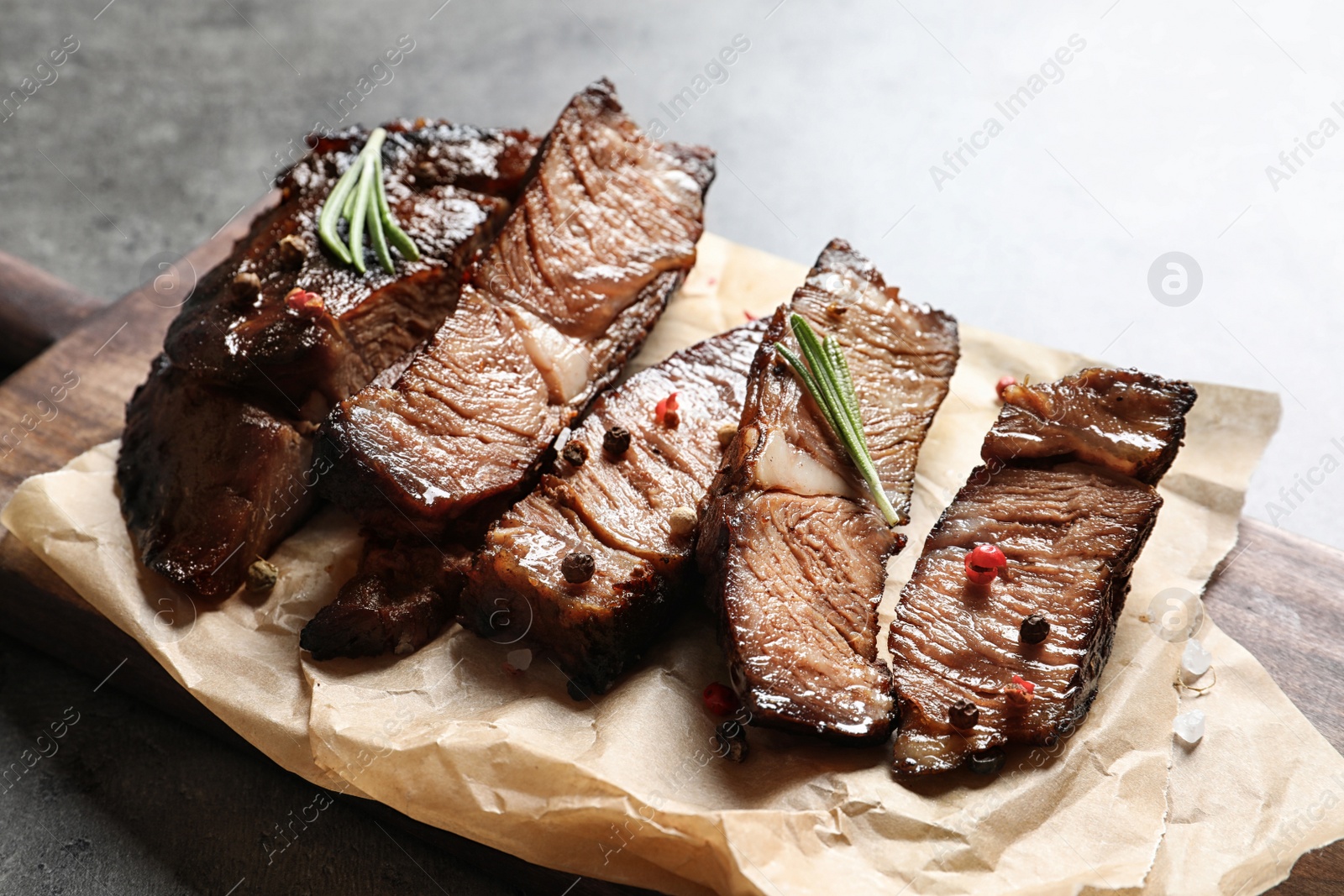 Photo of Delicious meat served for barbecue party on gray table