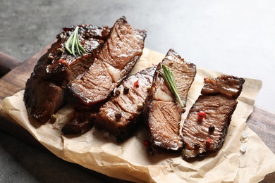 Photo of Delicious meat served for barbecue party on gray table