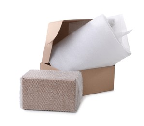 Photo of Cardboard boxes with bubble wrap and packaging foam on white background