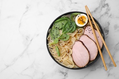 Photo of Delicious ramen with meat on white marble table, top view and space for text. Noodle soup