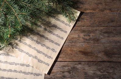 Photo of Composition with music sheets and space for text on wooden background, top view
