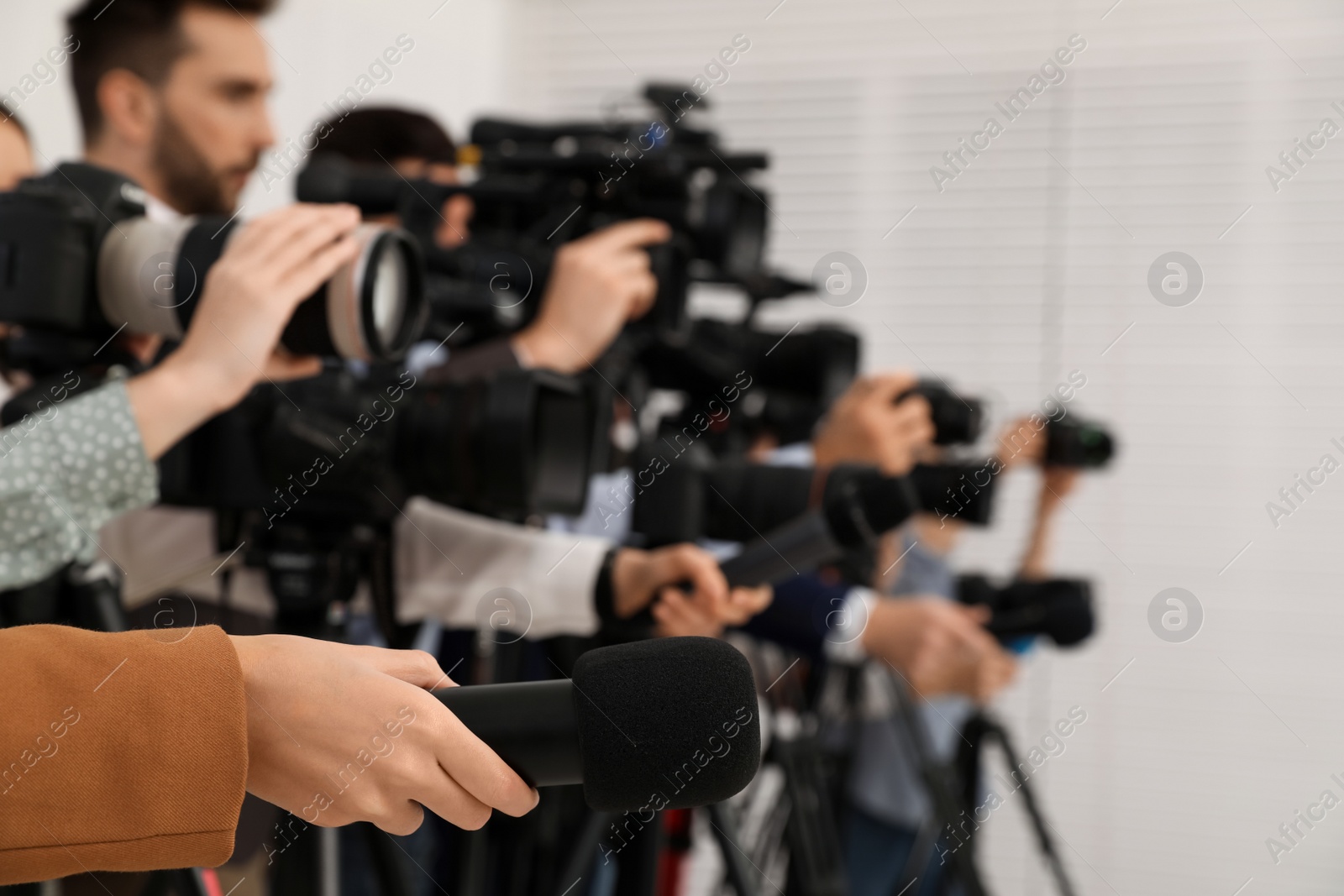 Photo of Group of journalists with cameras waiting for official person indoors, closeup