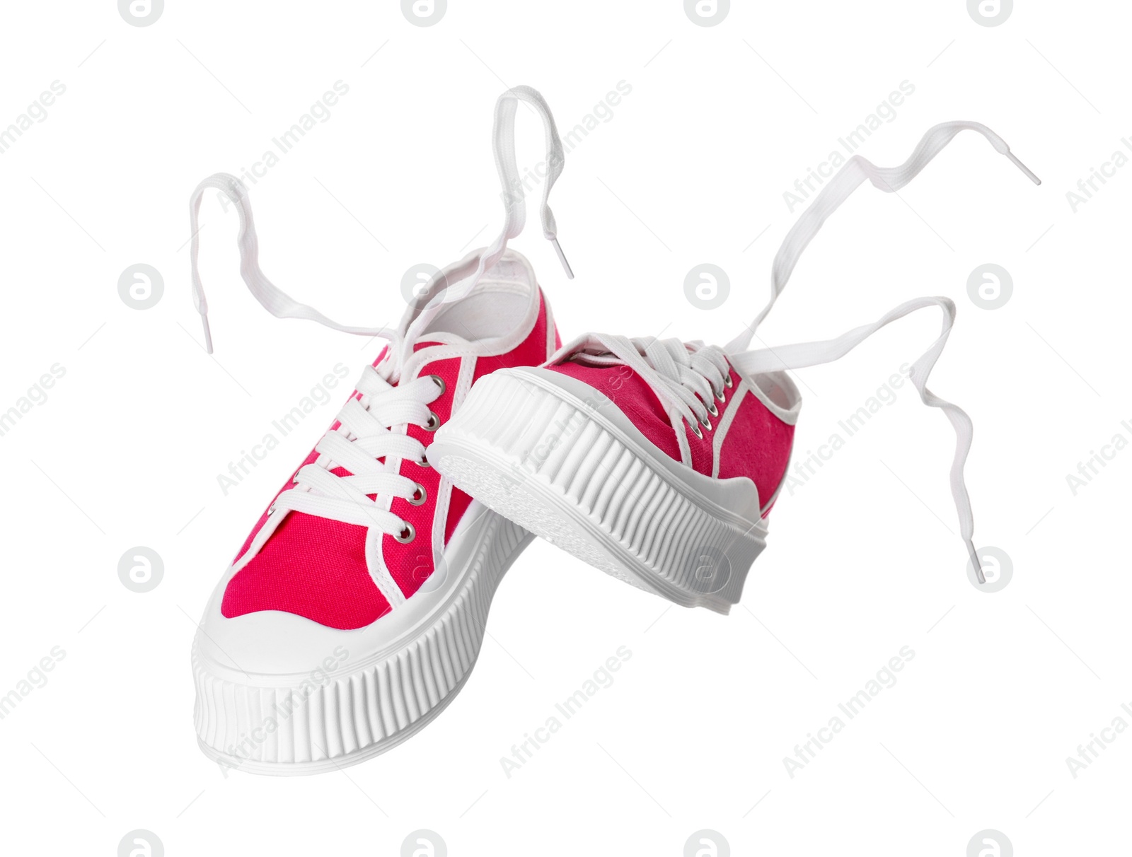 Photo of Pair of red classic old school sneakers on white background