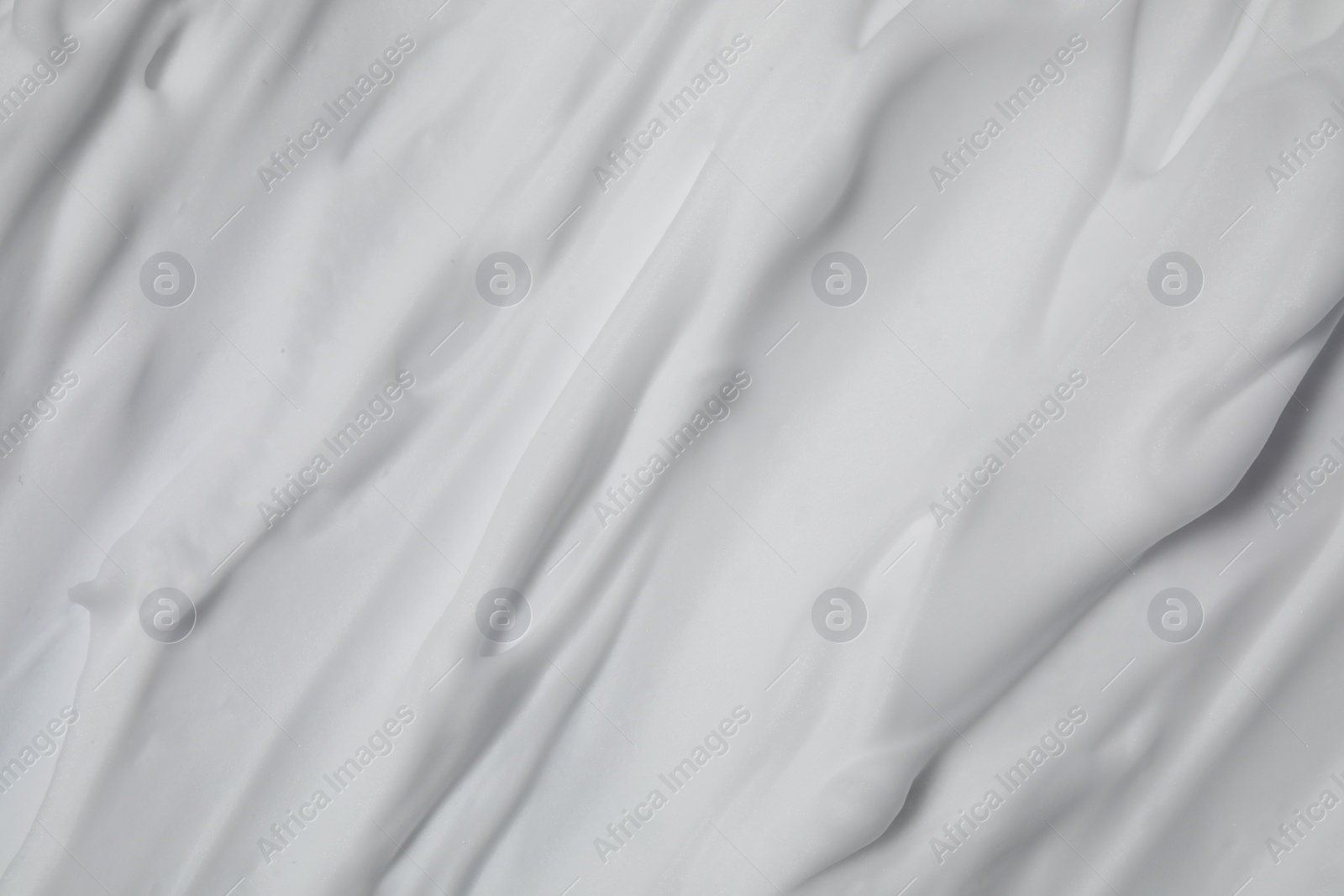 Photo of Texture of white shaving foam as background, top view