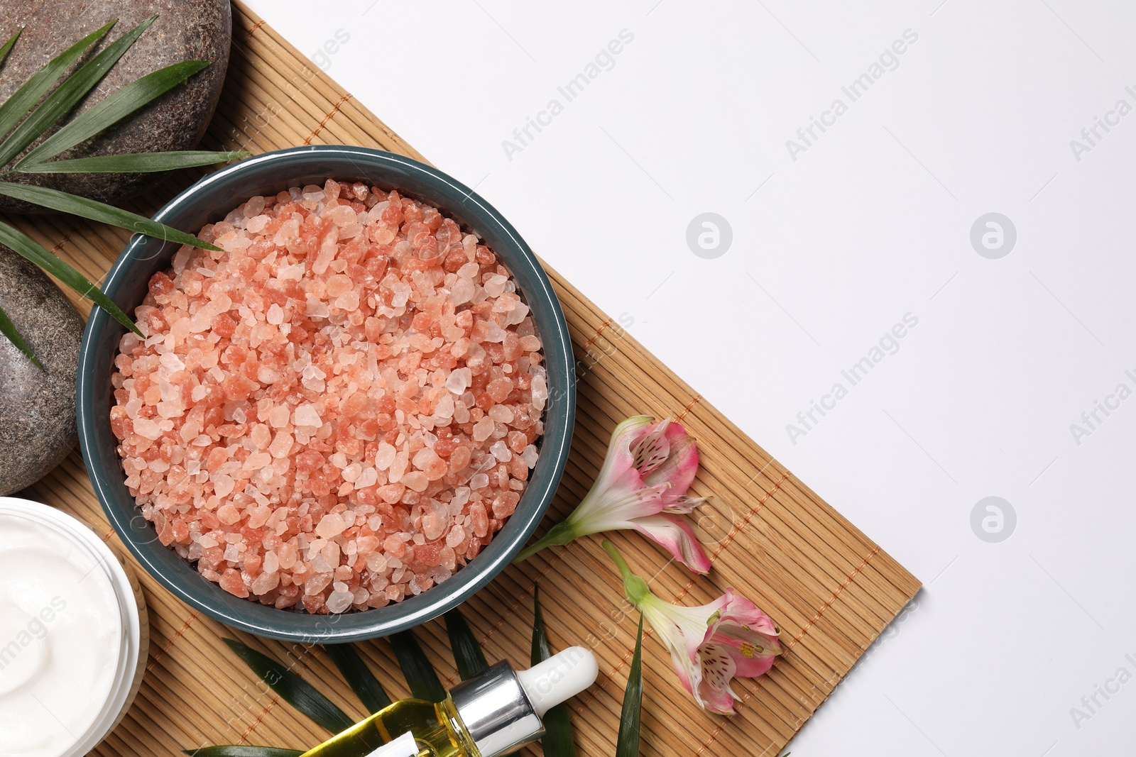 Photo of Flat lay composition with natural sea salt on white background. Space for text