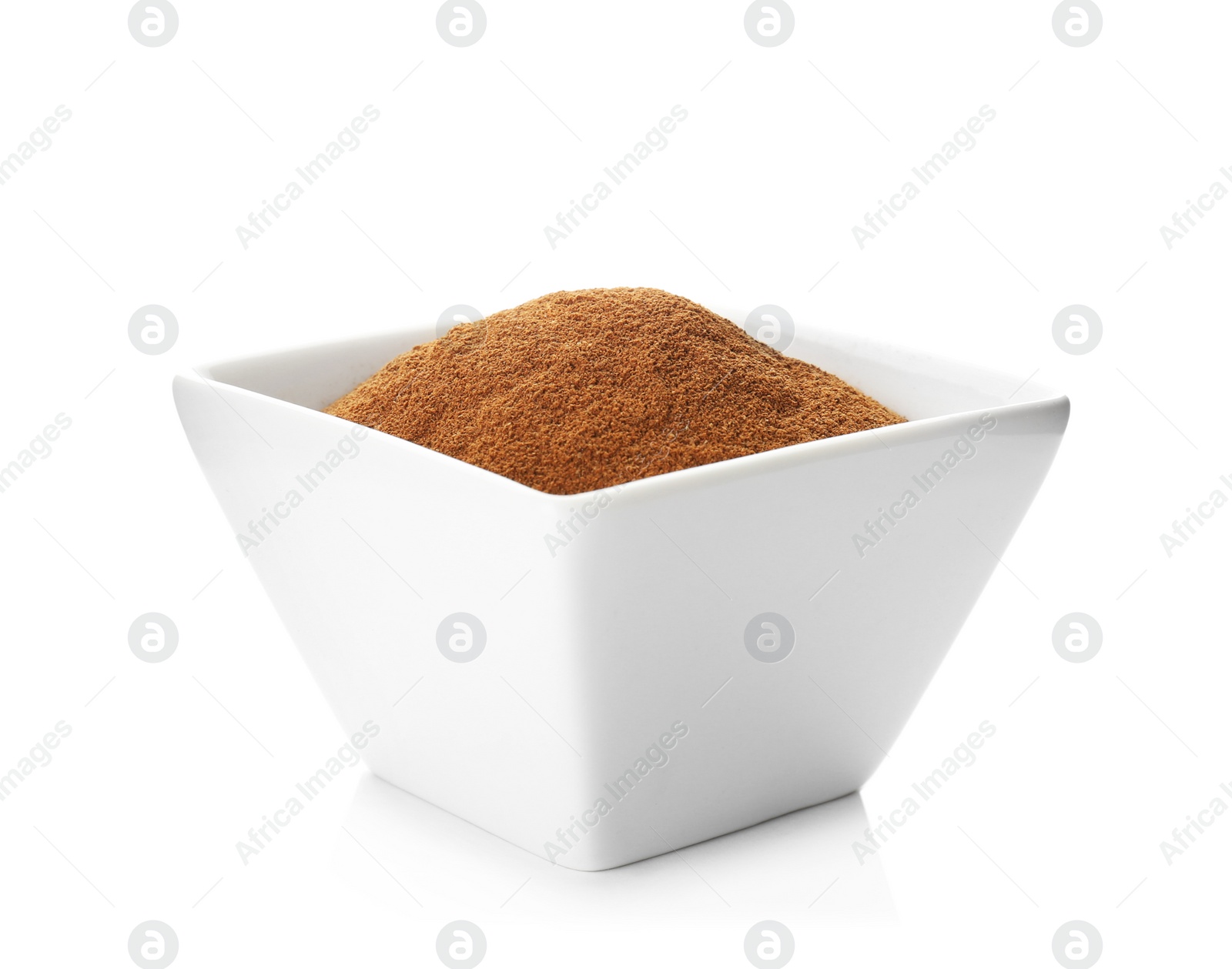 Photo of Bowl with aromatic cinnamon powder on white background