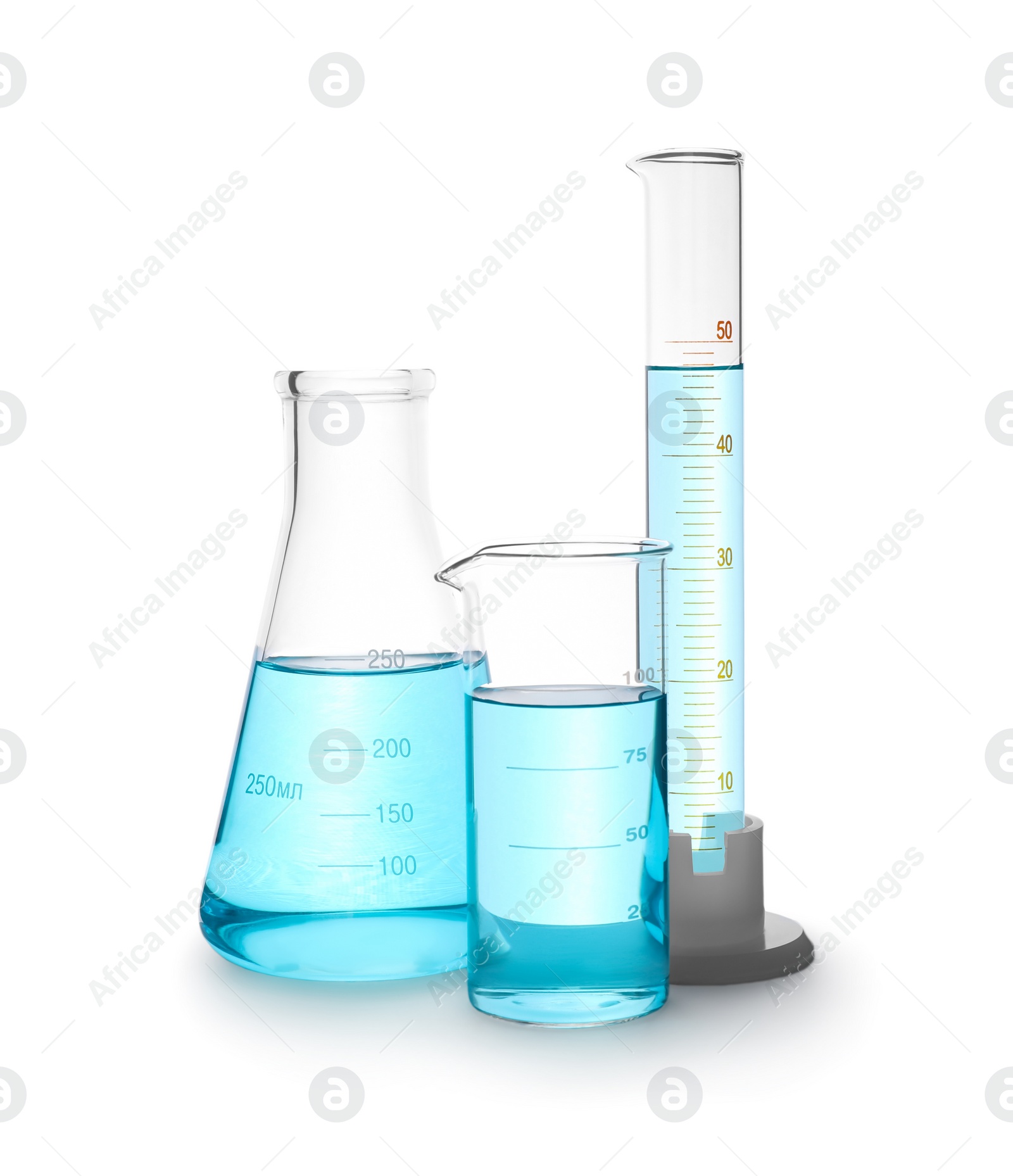 Photo of Different laboratory glassware with light blue liquid isolated on white