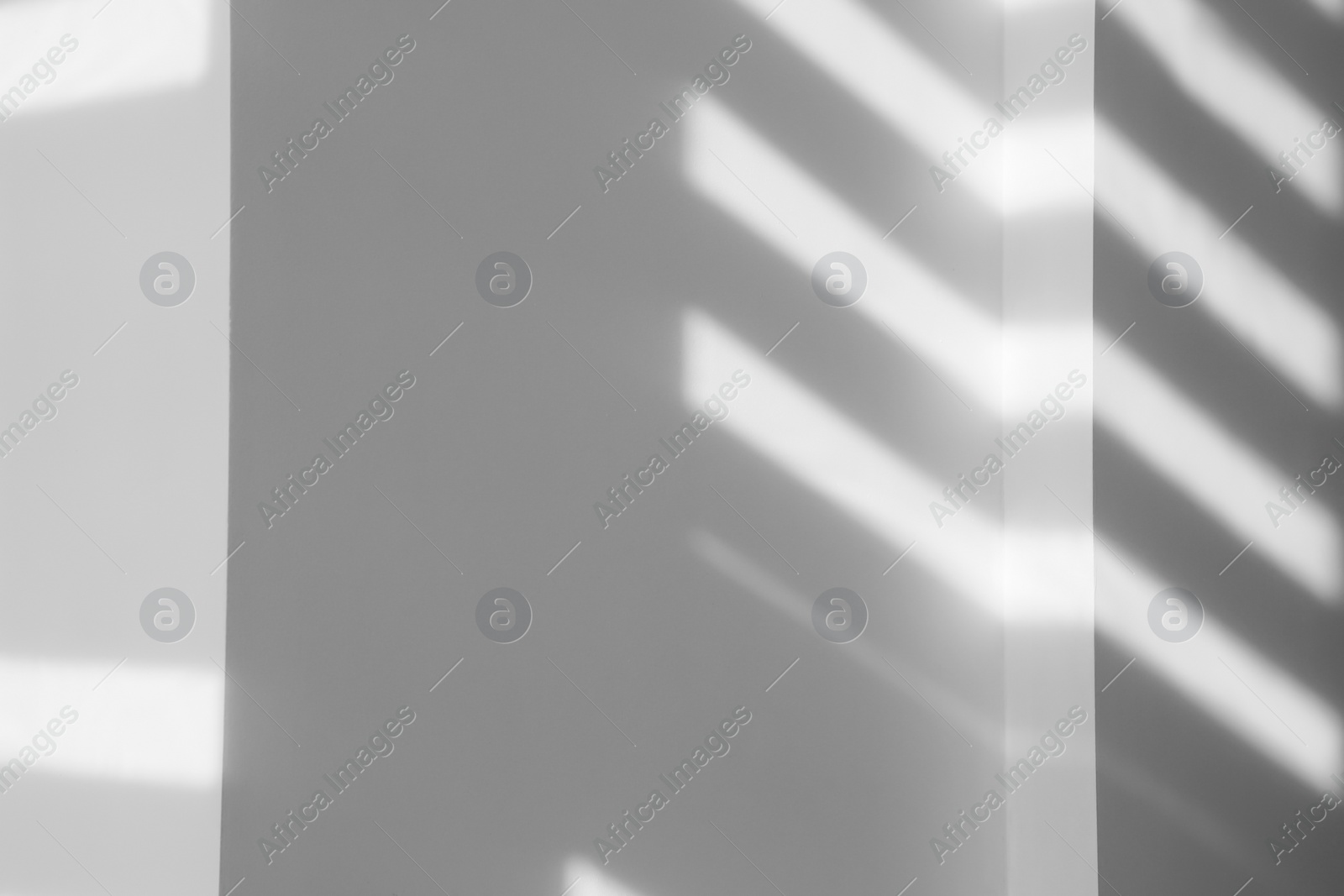 Image of Light and shadows falling on white wall