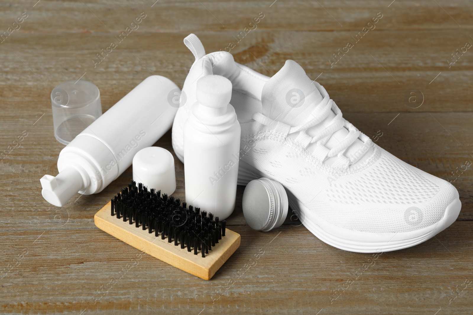 Photo of Composition with stylish footwear and shoe care accessories on wooden background